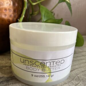 Unscented body butter jar on table.