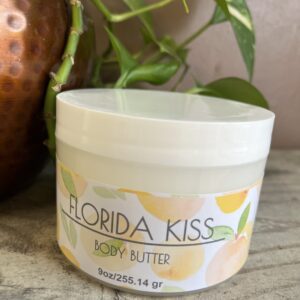 Body butter container with plant background.