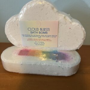 Cloud-shaped bath bomb with rainbow design.