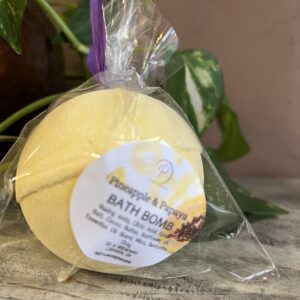 Yellow bath bomb in clear packaging.